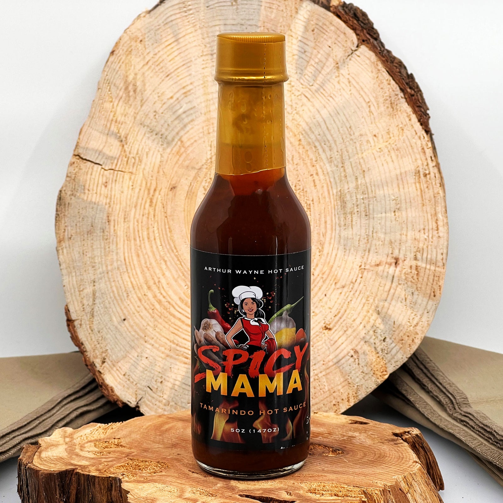 5 oz. bottle of Spicy Mama Hot Sauce, with Peppers (Habanero, Fresno), Tomato, Mango, Tamarind Concentrate, Cocoa, Lemon Juice, and spices made in Montana by Arthur Wayne Hot Sauce