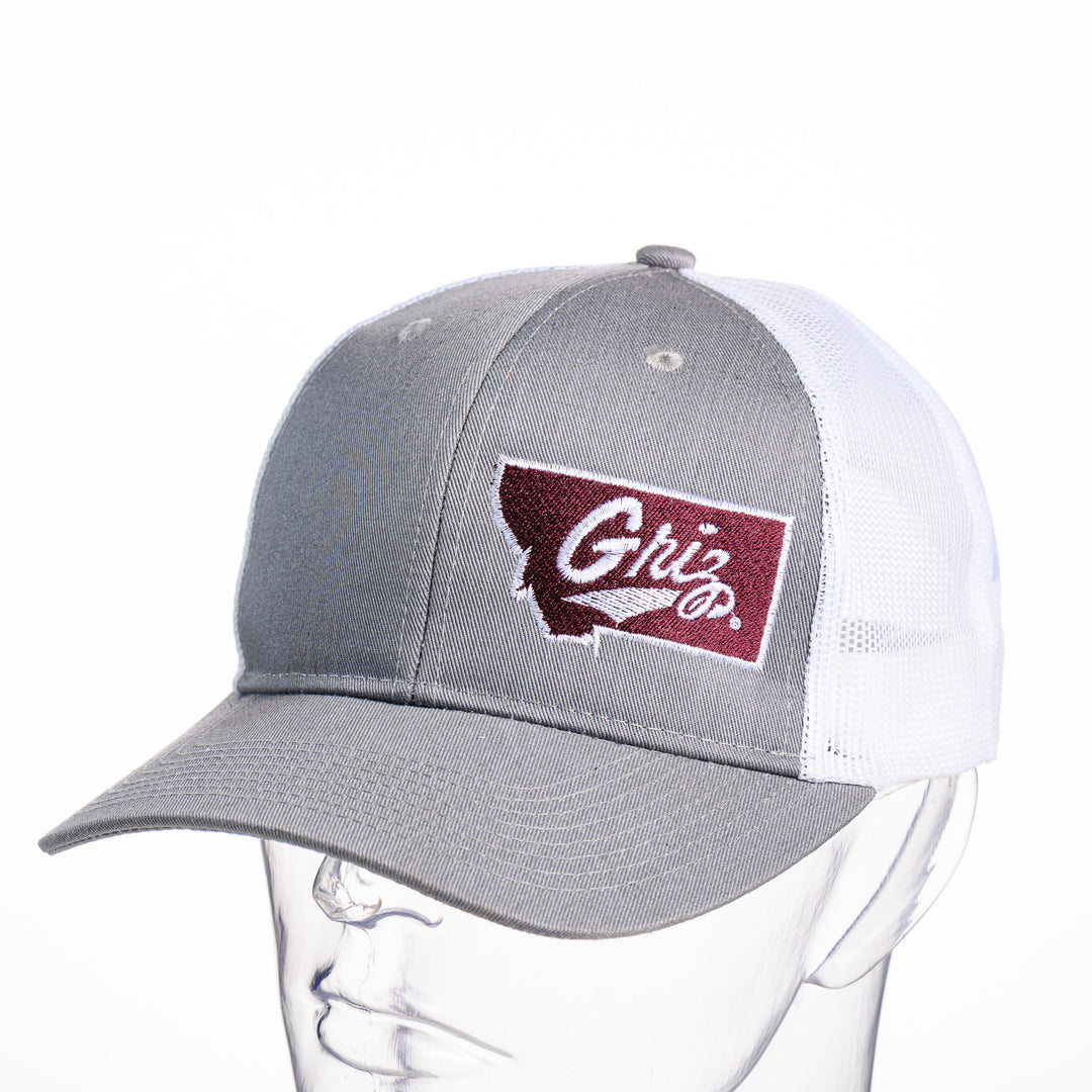 Blue Peaks Creative's grey and white Trucker Cap with the Montana Griz Script design embroidered in maroon and white, front