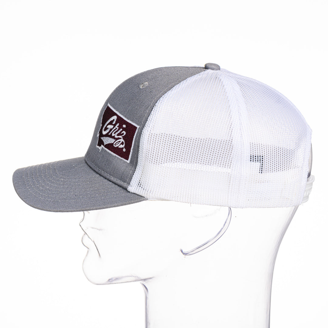 Blue Peaks Creative's grey and white Trucker Cap with the Montana Griz Script design embroidered in maroon and white, side