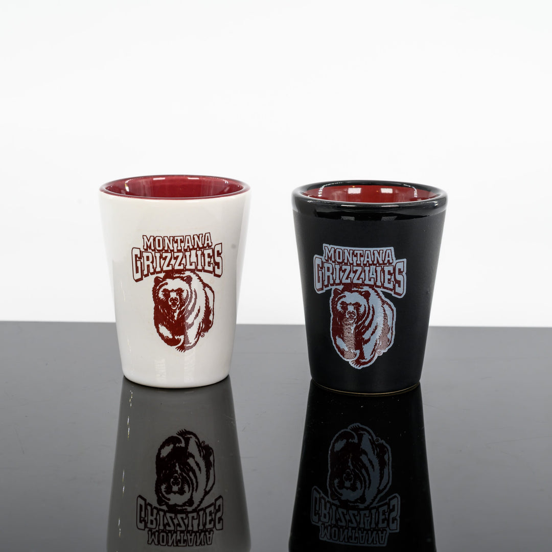 Blue Peaks Creative's Ceramic Shot Glass with Montana Grizzlies Charging Bear design, white and black with red interior