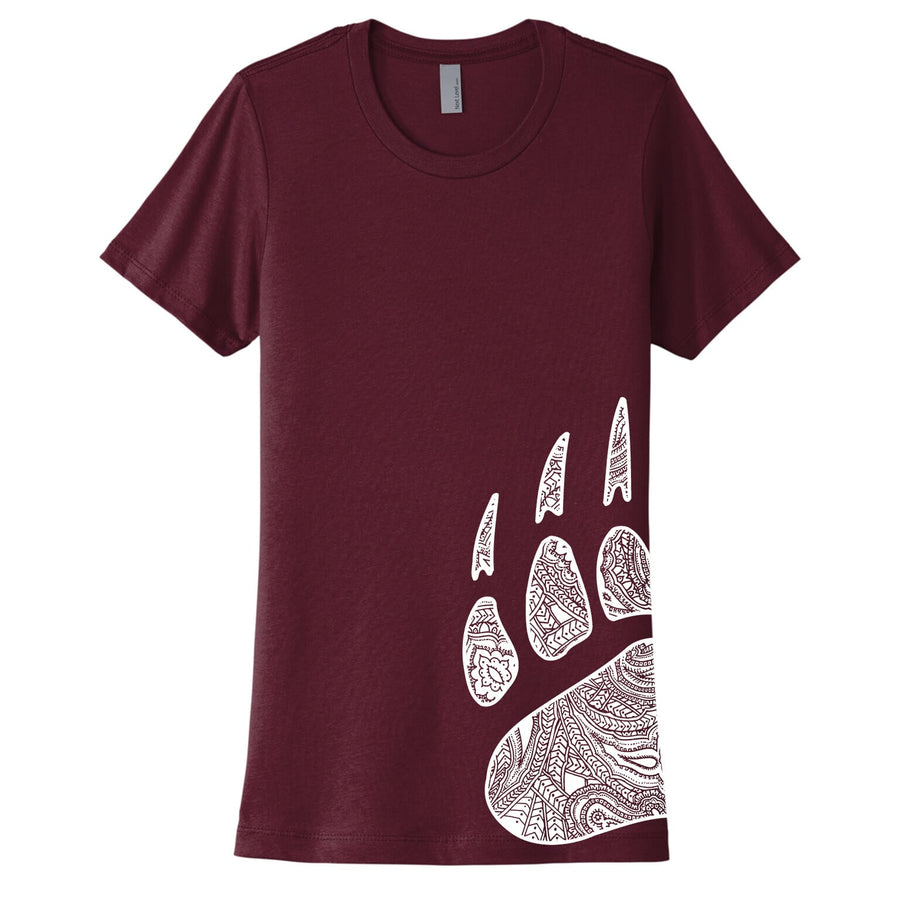 A maroon ladies t-shirt featuring a screen print of a white University of Montana Griz paw filled with a paisley pattern, printed on the left side of the shirt.