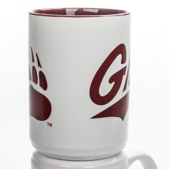 Blue Peaks Creative's white Coffee Mug with maroon interior, with the Griz Script and Paw in maroon, front